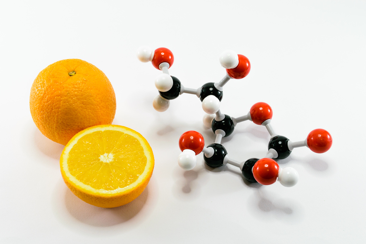 Orange and vitamin C structure model (Ascorbic acid)